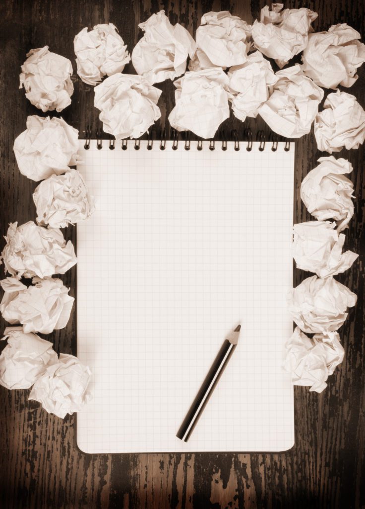 Blank Notepad with Crumpled Paper Around It