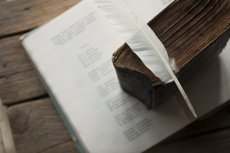 Poem, Feather, And Vintage Book